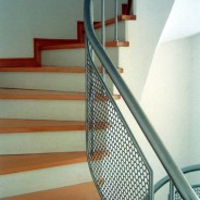 Railing with protective mesh