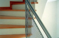 Railing with protective mesh